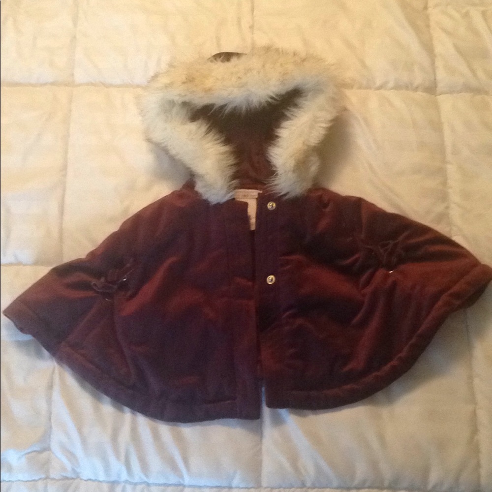 Sleeveless suede jacket with fur hood